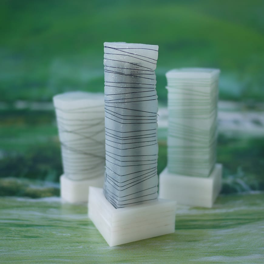 Three silicon columns wrapped in thread
